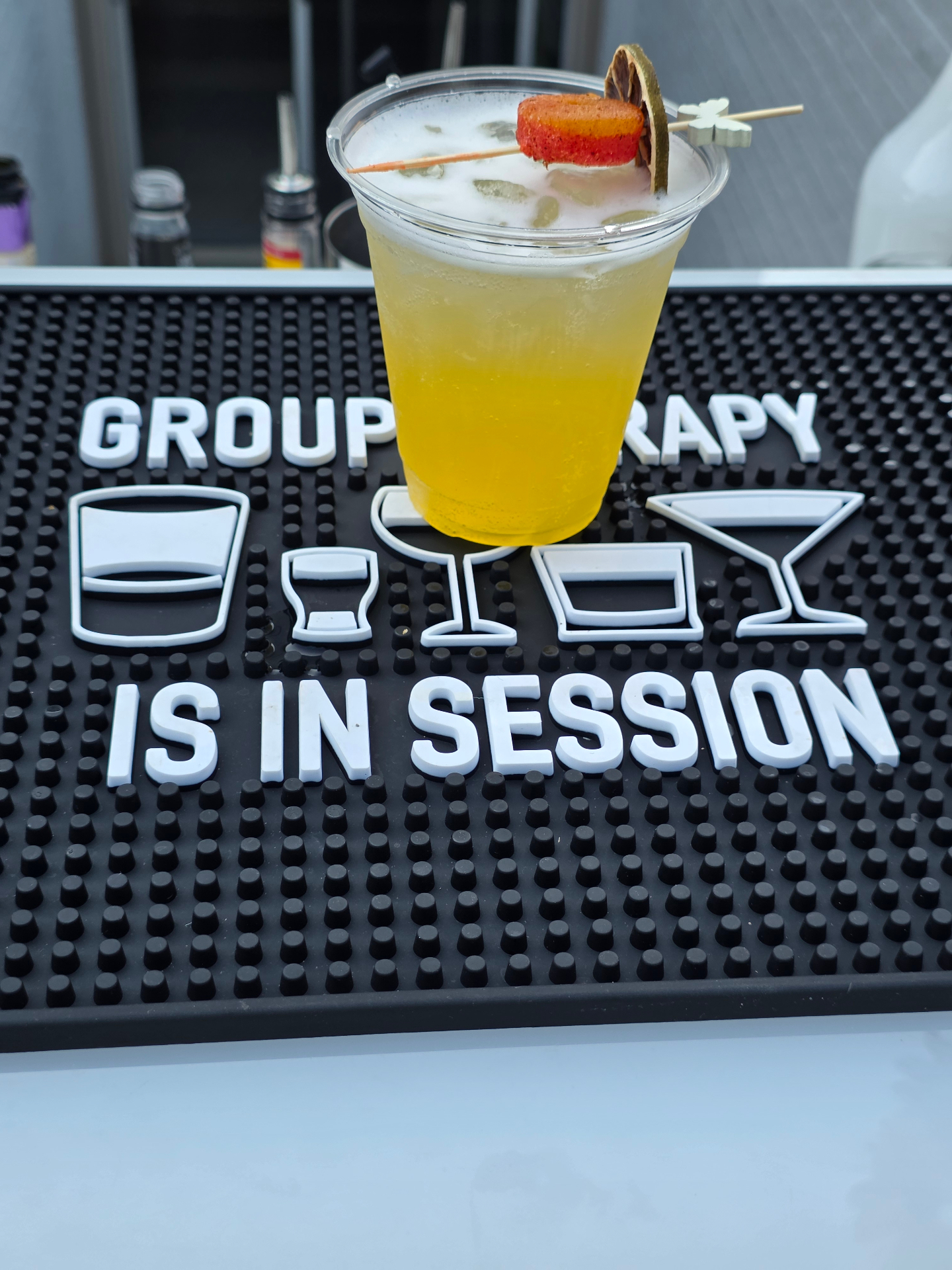 Mango splash signature drink on the Vibe Box bar mat